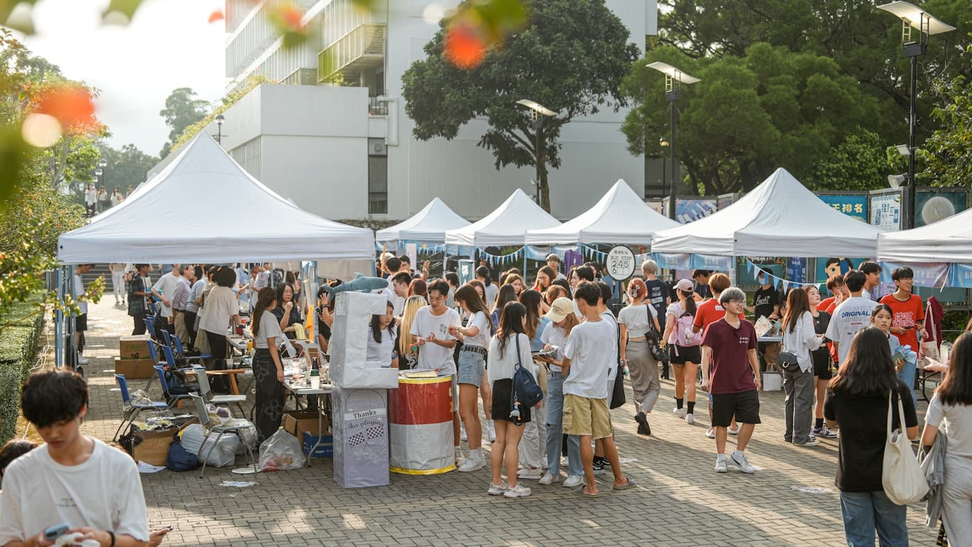 People browsing vendor tents at an outdoor festival market